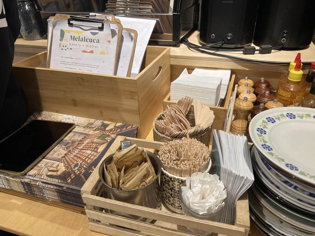 Melaleuca Bakery and Bistrot counter with menus, cutlery, and condiments in Florence