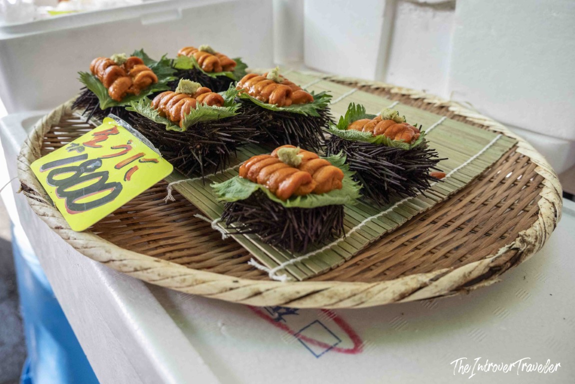 Fresh uni (sea urchin) served in shells at Tsukiji fish market, priced at 1000 yen each
