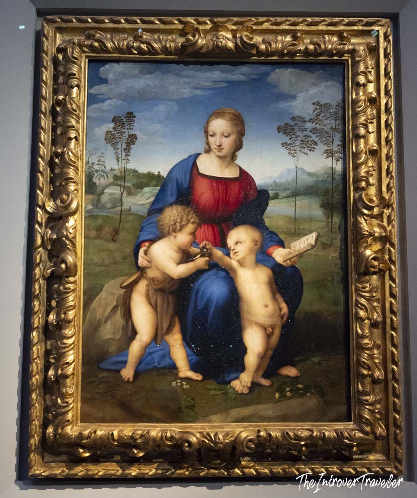 Raphael's Madonna of the Goldfinch painting displayed in an ornate gold frame at the Uffizi Gallery, Florence