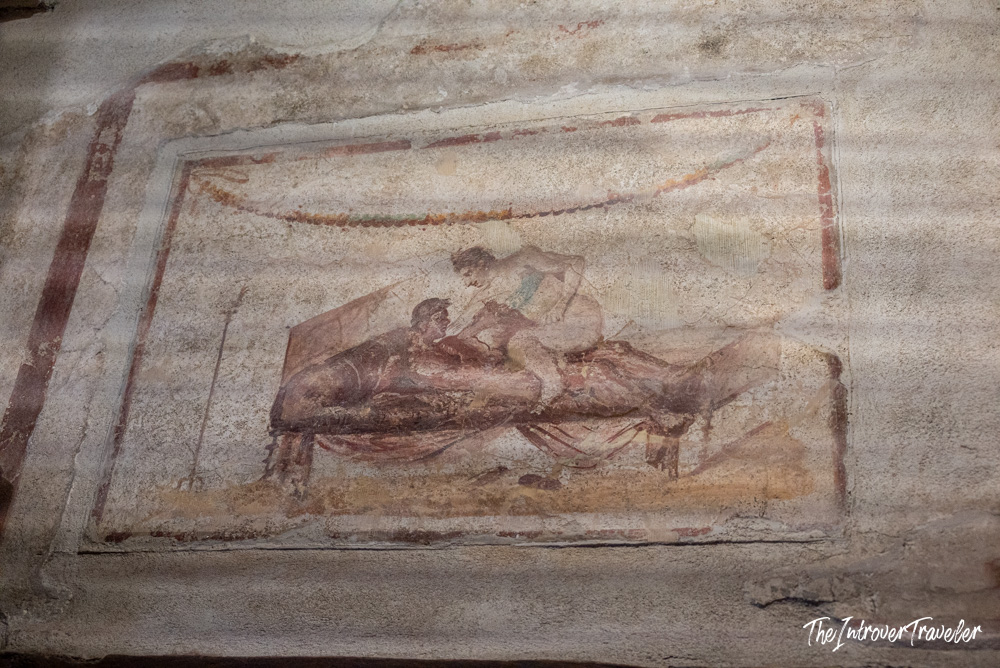 Erotic fresco on the wall of the Lupanar brothel in ancient Pompeii, Italy