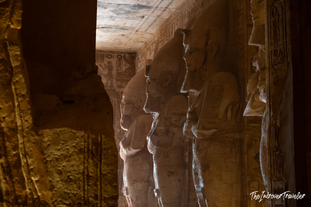 Osiride pillars of Ramesses II inside Abu Simbel Great Temple, with painted hieroglyphic ceiling