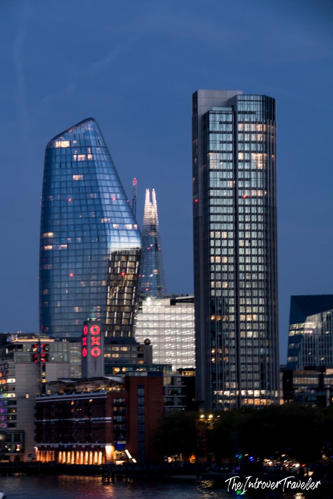 London South Bank skyline at dusk, with One Blackfriars, the Shard, and OXO Tower lit up