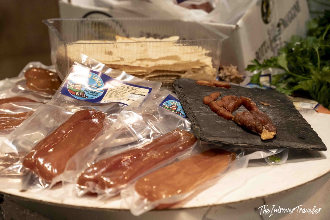 Bottarga di muggine (Sardinian mullet roe) in vacuum packs displayed at a coastal fish market