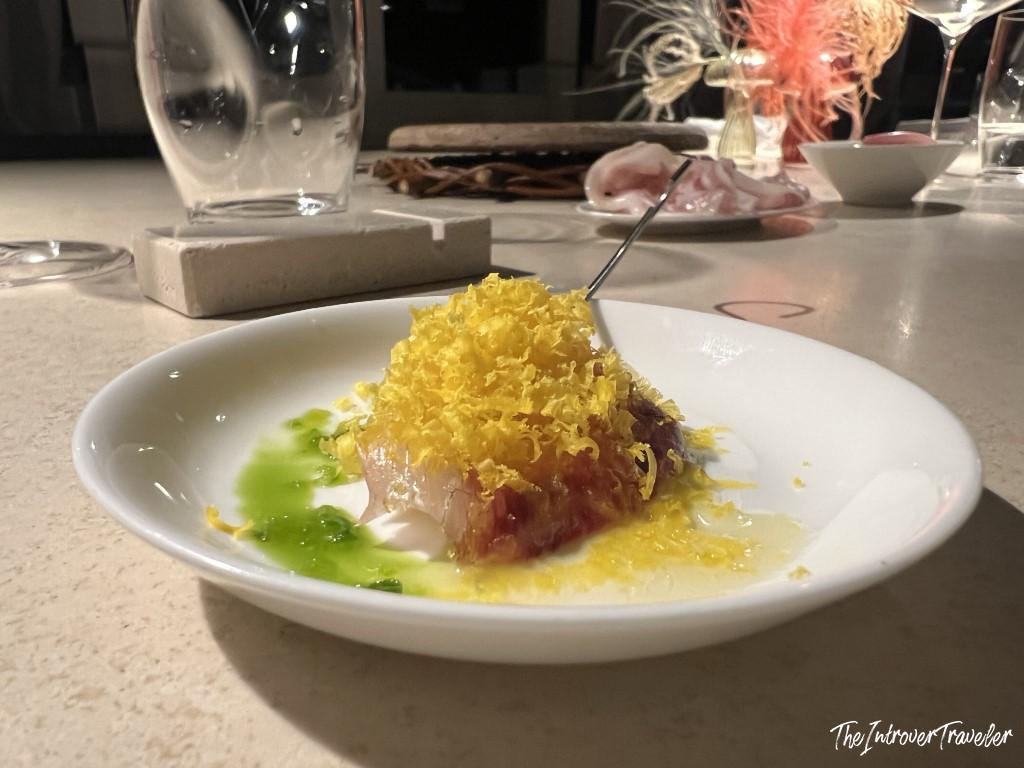 Elegant seafood crudo with lemon zest and herb oil, served at Trattoria Da Lucio in Rimini