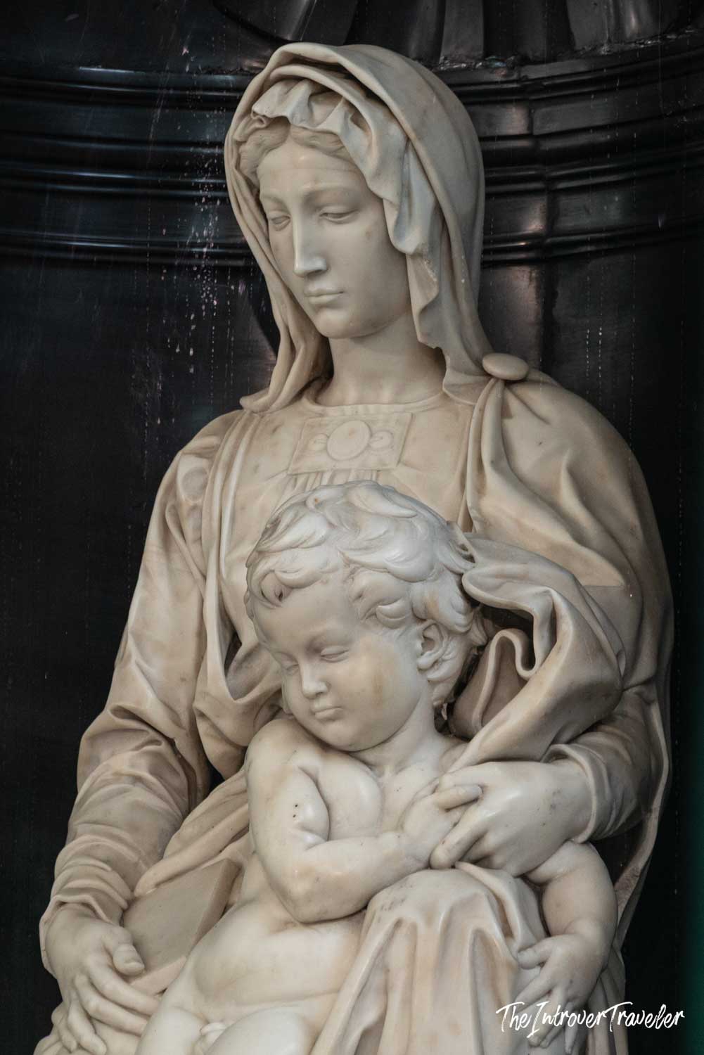 Michelangelo's Madonna of Bruges, close-up of Mary cradling the Christ Child in white marble