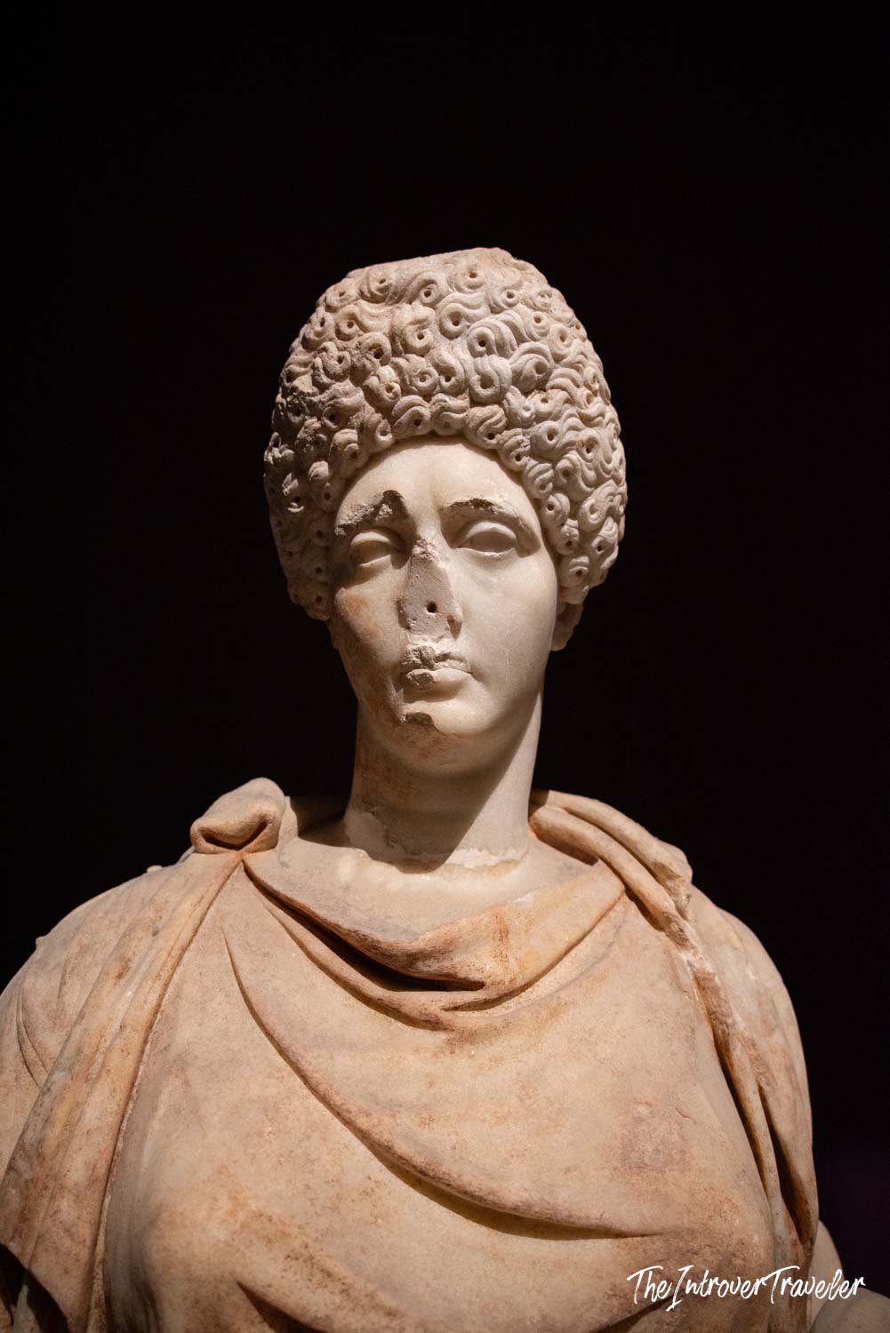 Ancient Roman marble bust of a woman with elaborate Flavian-era curled hairstyle, Istanbul Archaeological Museum