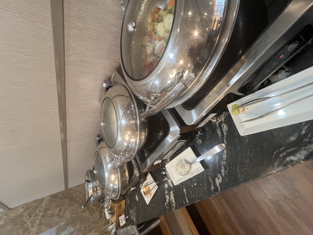 Heated chafing dishes with hot food options at the Turkish Airlines Lounge JFK buffet station