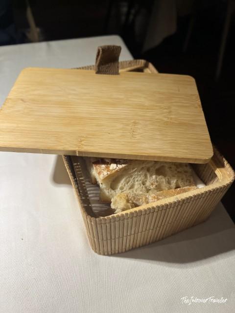 Bread service in a bamboo box at L'Ebbrezza di Teonilla, a fine dining restaurant in Naples