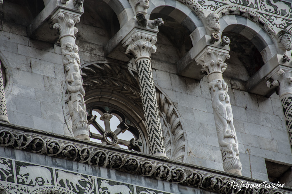 Ornate carved columns and arches on the facade of Lucca Cathedral, San Martino, Tuscany