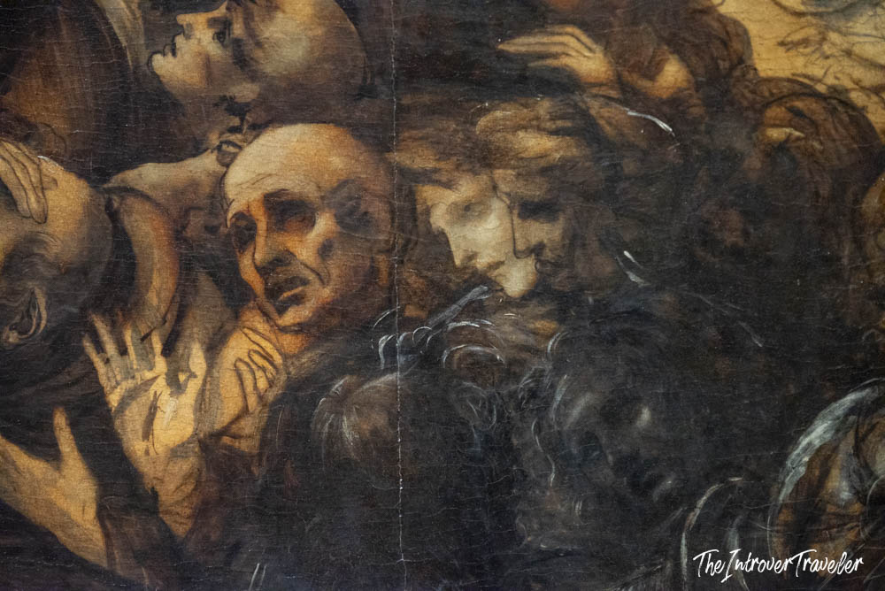 Close-up detail of expressive figures in a Renaissance painting at the Uffizi Gallery, Florence