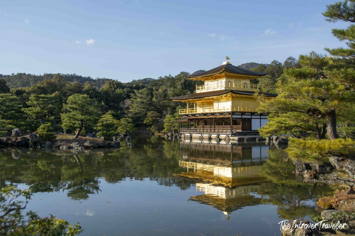 Kinkaku-ji Golden Pavilion reflected in Kyoko-chi pond, surrounded by pine trees in Kyoto