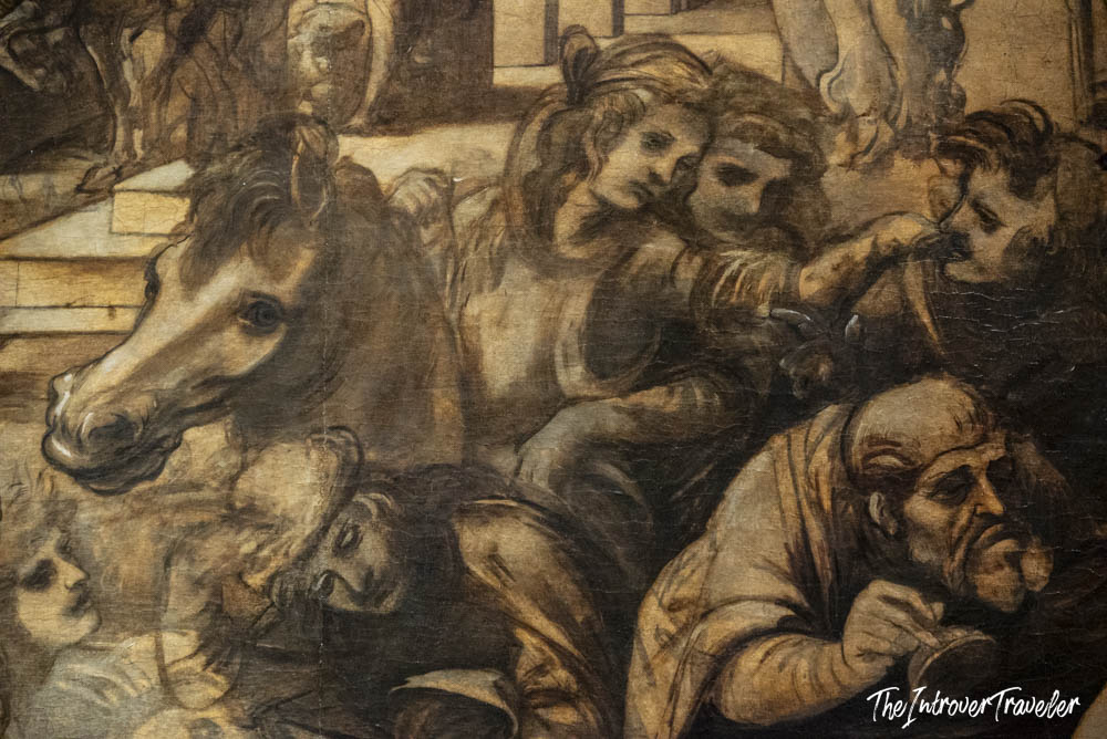 Close-up detail of a dramatic Renaissance painting with figures and a horse at the Uffizi Gallery, Florence