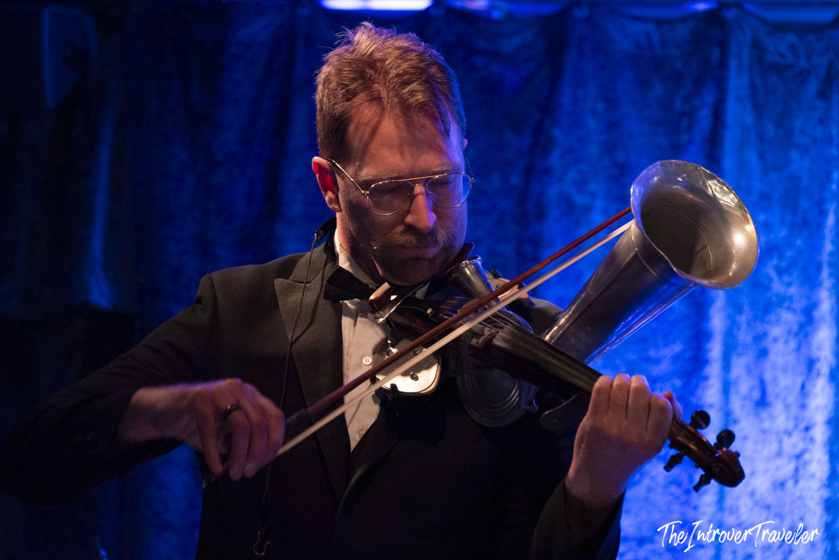 Musician playing a horn violin hybrid instrument on stage at Birdland Jazz Club, New York