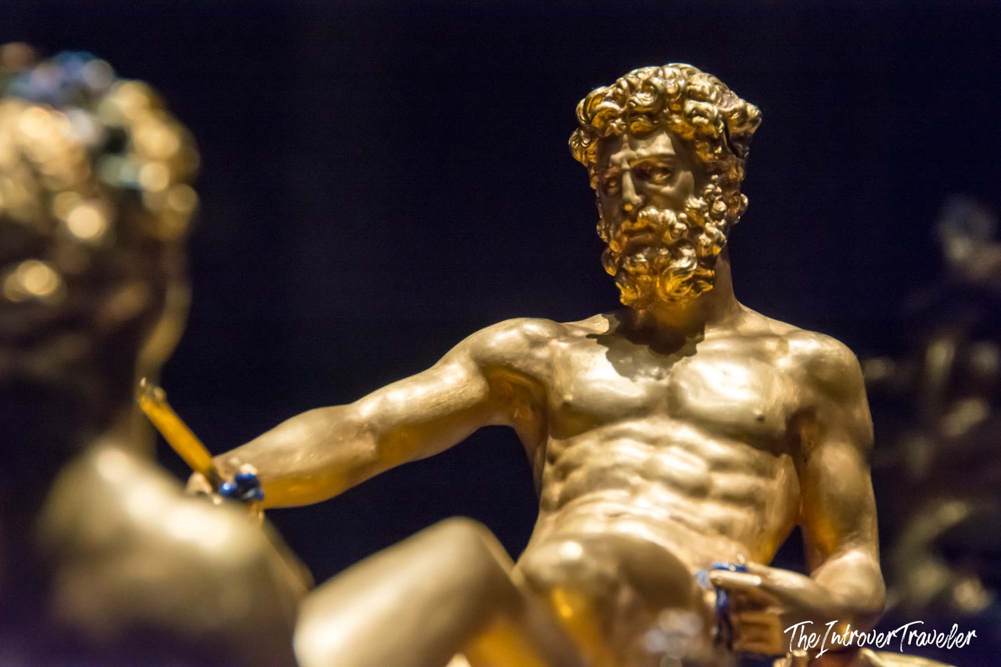 Gold Neptune figure on the Cellini Salt Cellar, close-up of the bearded sea god holding his trident