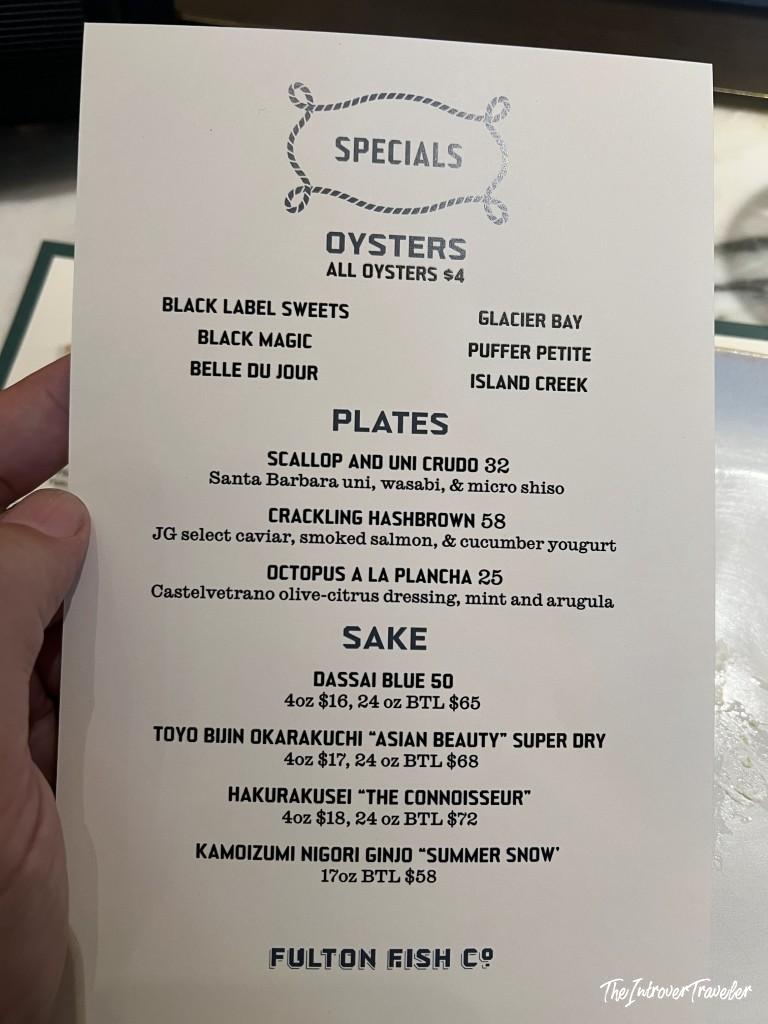 Fulton Fish Co specials menu showing oysters, plates, and sake selections at Pier 17 NYC