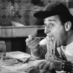 Alberto Sordi eating spaghetti in the iconic scene from An American in Rome, 1954