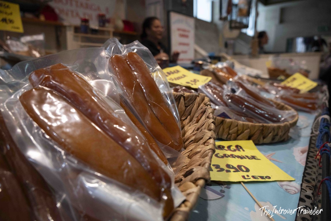 Bottarga fillets in vacuum-sealed bags sold at a coastal Italian fish market stall