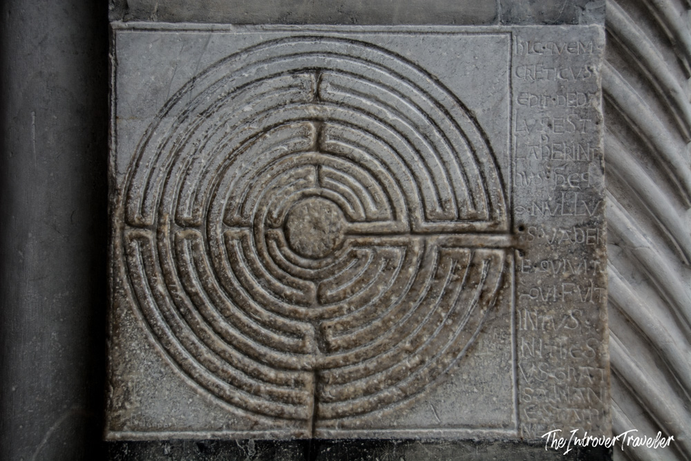 Stone labyrinth carving on a column of Lucca's Cathedral of San Martino, with Latin inscription