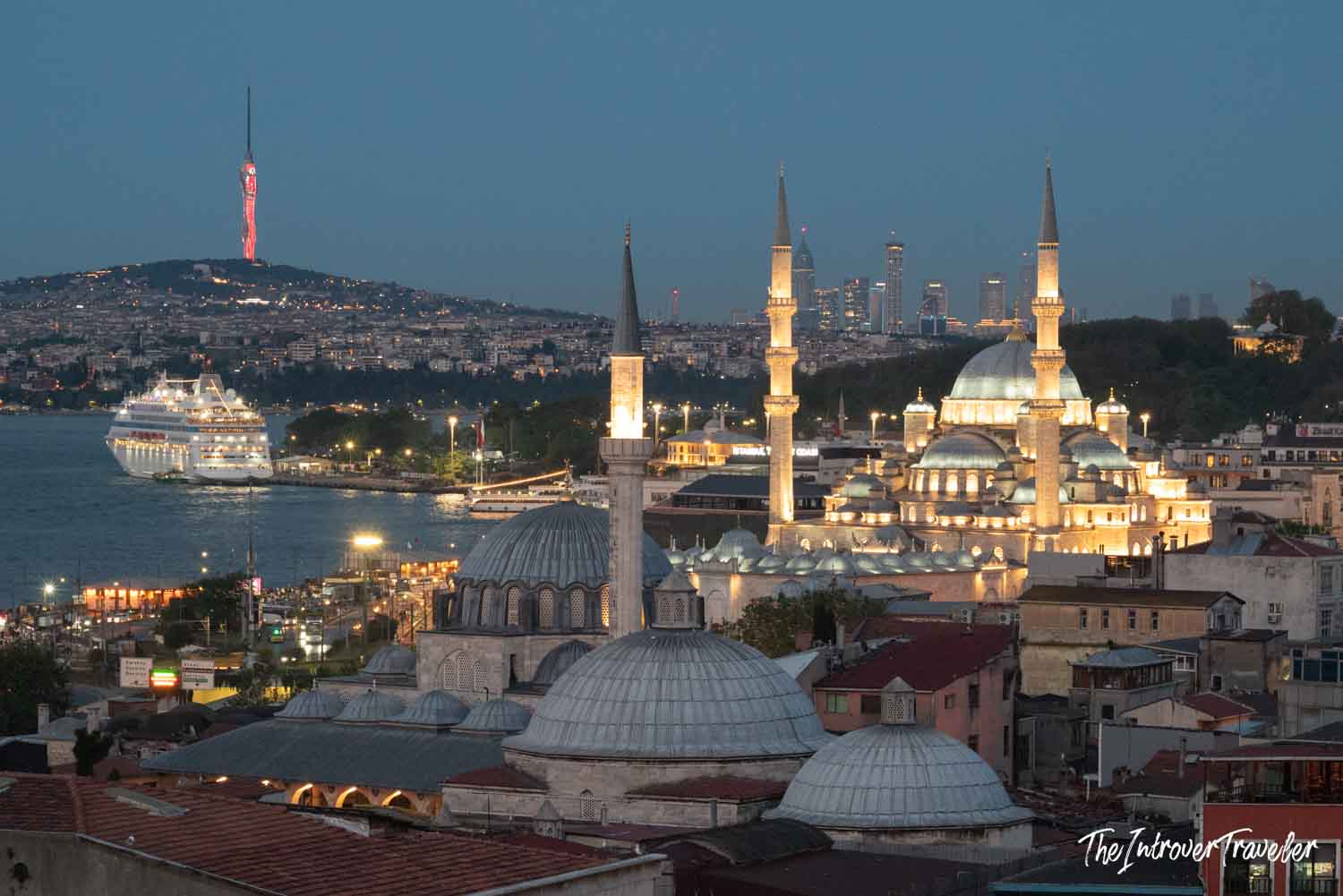 Istanbul skyline at dusk featuring the illuminated New Mosque, Bosphorus, and Camlica Tower beyond
