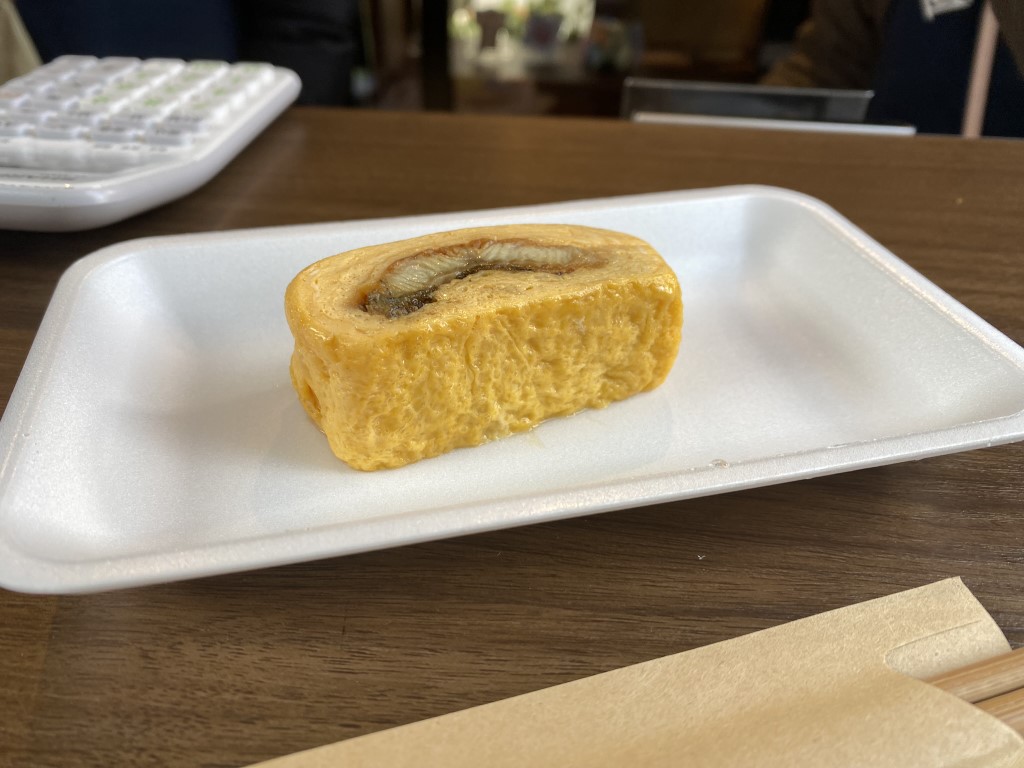 Thick tamagoyaki slice with fish filling, a popular Tsukiji market street food in Tokyo