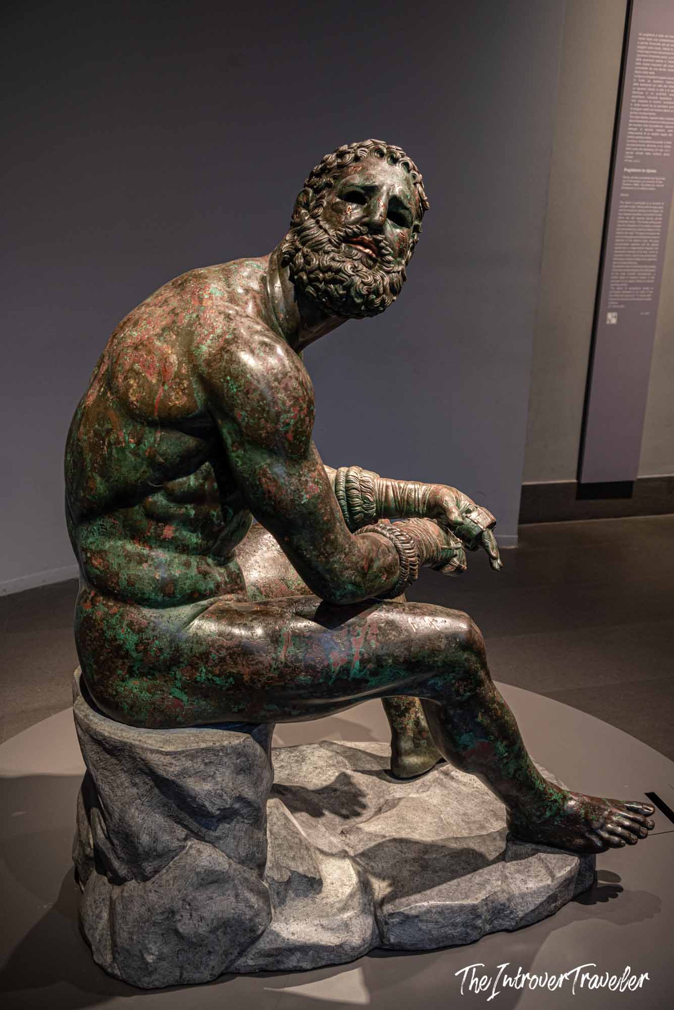 Boxer at Rest, ancient Greek bronze sculpture at Palazzo Massimo, Rome, showing a weary seated athlete