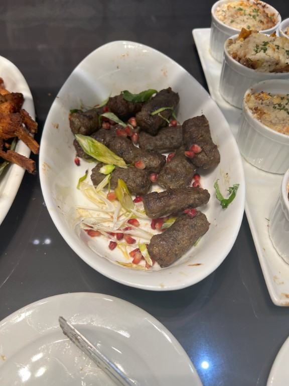 Spiced meat bites with pomegranate seeds and greens, served at La Valette Lounge, Malta Airport