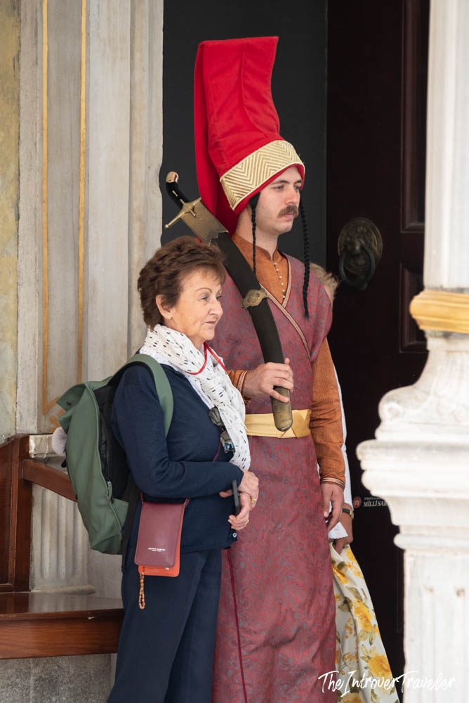 Tourist posing with an Ottoman-costumed guard at the entrance of Topkapi Palace, Istanbul
