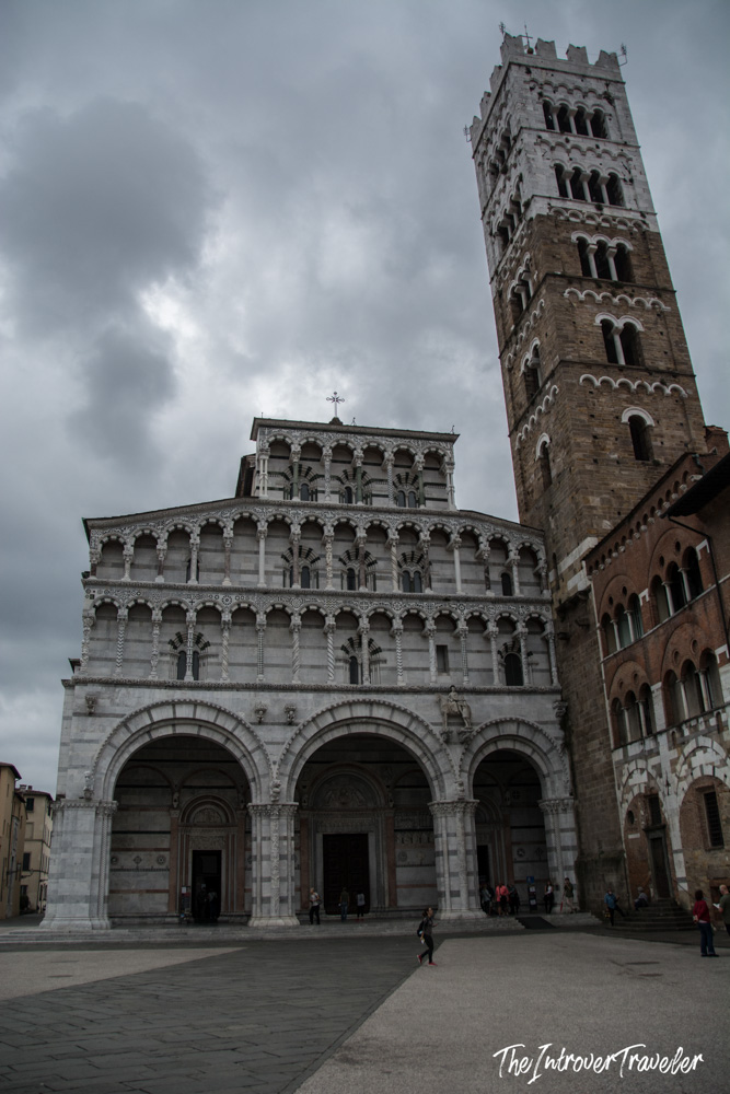 Lucca Cathedral of San Martino, with its ornate Romanesque marble facade and tall brick bell tower, Tuscany