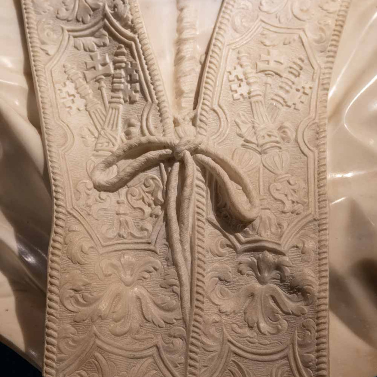 Close-up of intricately carved marble vestment detail on a Bernini sculpture at Palazzo Barberini
