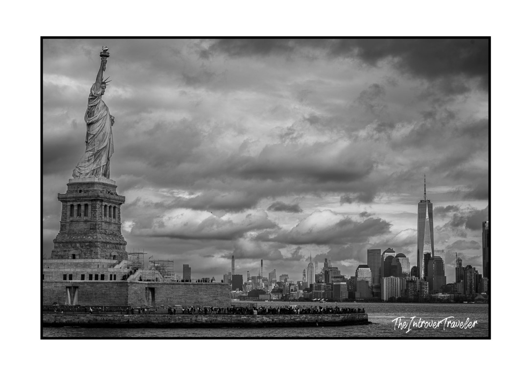 Statue of Liberty with Manhattan skyline and One World Trade Center, black and white, New York