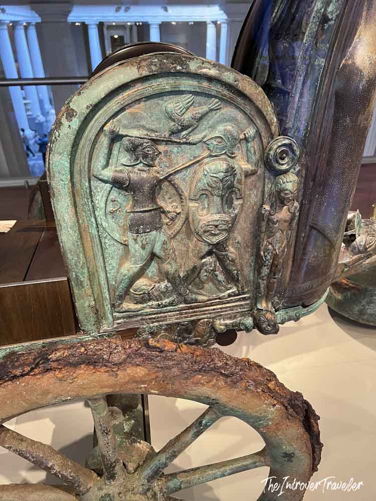 Ancient Greek bronze chariot with warrior relief panels on display at the Metropolitan Museum of Art