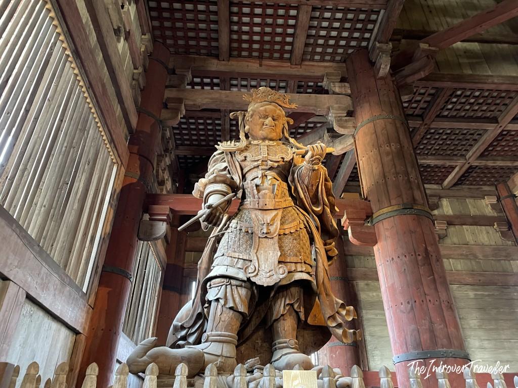 Tall wooden guardian deity statue (Tamonten) inside Todaiji Temple, Nara, Japan