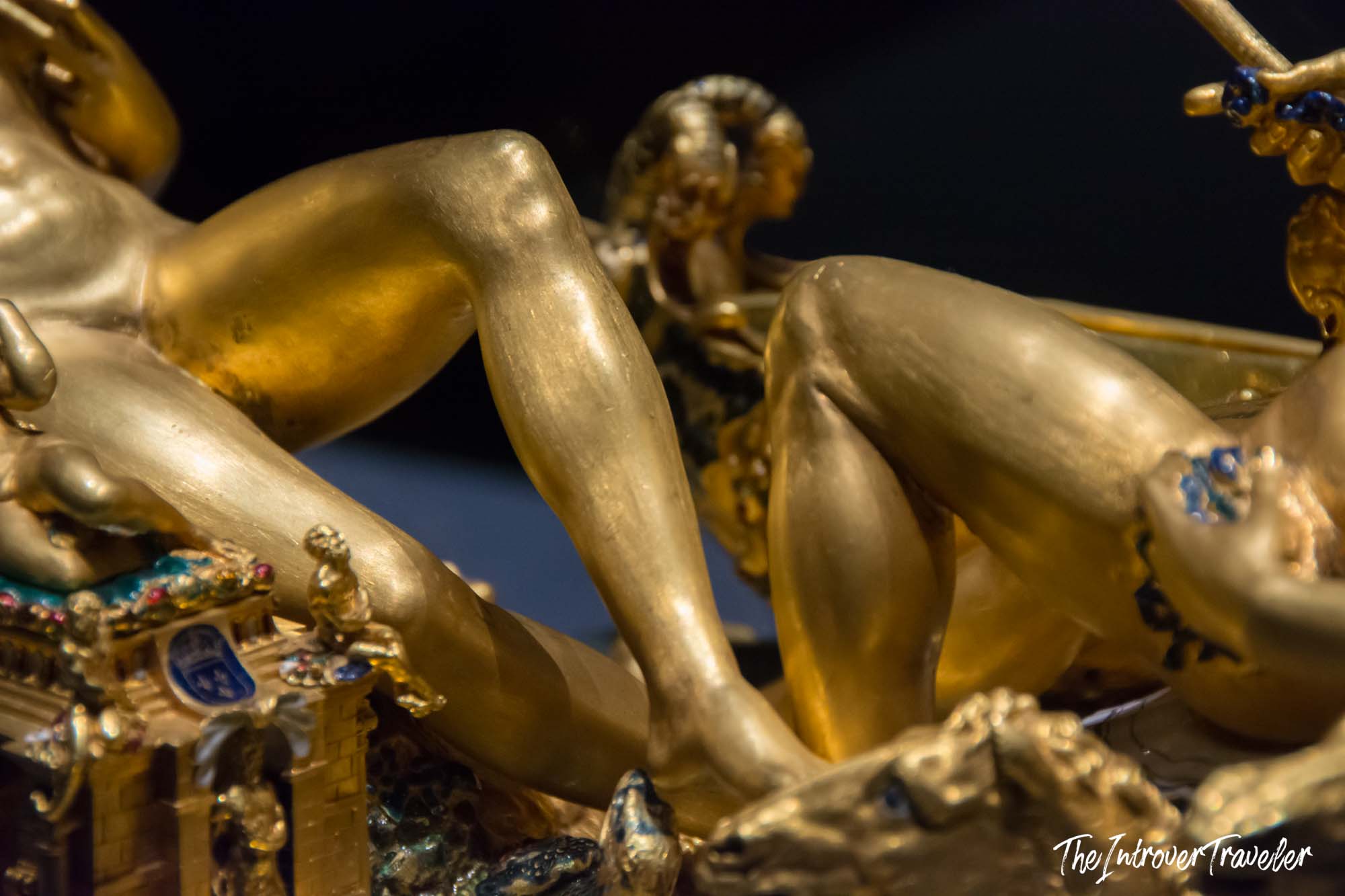 Close-up of gilded figures on Cellini's Salt Cellar of Francis I, showing intricate gold craftsmanship