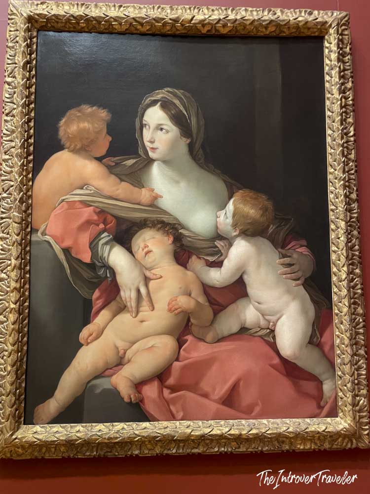Baroque painting of Madonna with Christ Child and cherubs in gilt frame at the Met New York