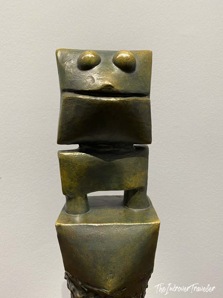 Small abstract bronze sculpture with geometric face on display at the Albertina Museum, Vienna