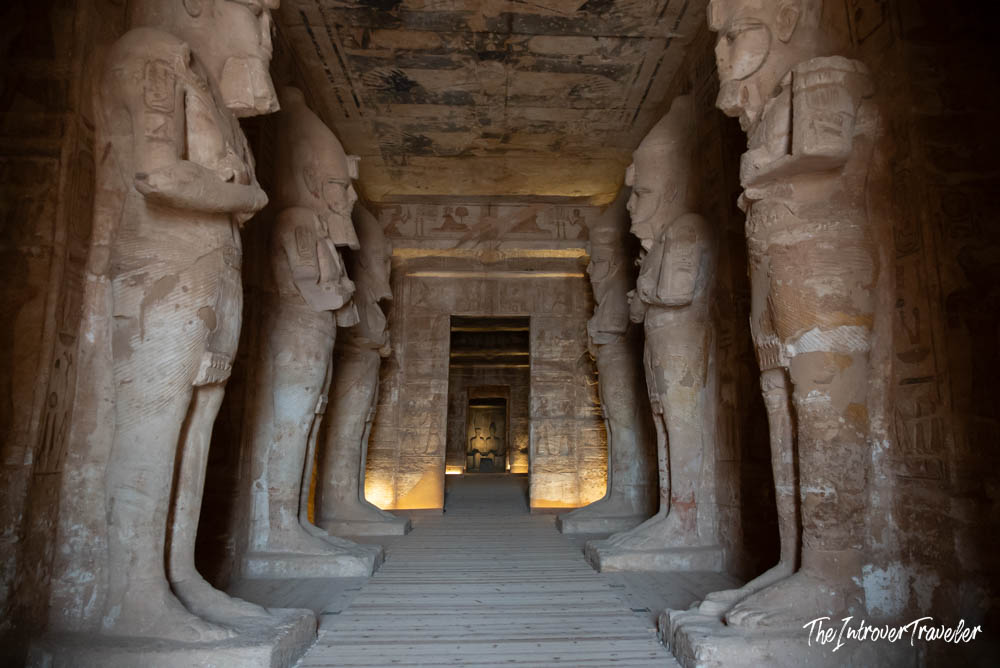 Interior of Abu Simbel temple, with colossal Ramses II statues lining the hypostyle hall toward the sanctuary