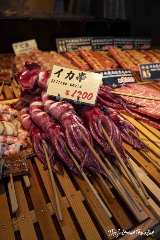 Ika-kushi grilled squid skewers priced at 1200 yen at Tsukiji fish market, Tokyo