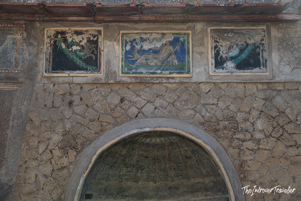 Ancient Roman frescoes above an arched nymphaeum in the Herculaneum excavations, Italy