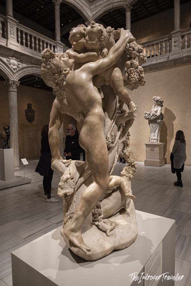Baroque marble sculpture of intertwined figures on display inside the Metropolitan Museum of Art, New York