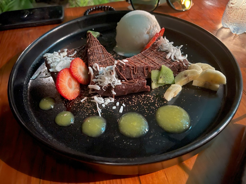 Choco-Coco Pie at Kondesa Cozumel, dark chocolate tart with coconut, fresh fruit, and ice cream scoop