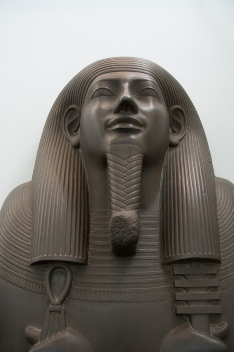 Dark granite pharaoh statue in the Egyptian wing of the British Museum, London
