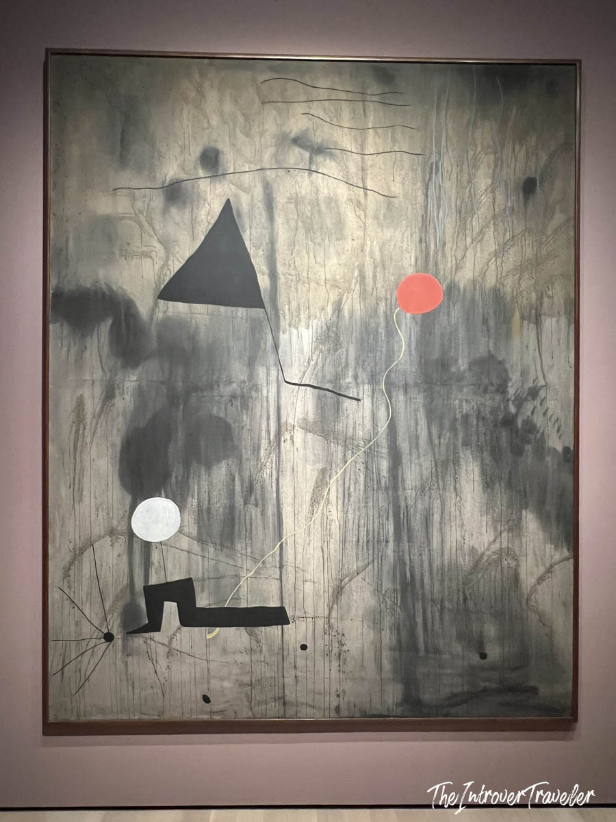 Joan Miró abstract painting at MoMA New York, featuring bold shapes on a grey textured canvas