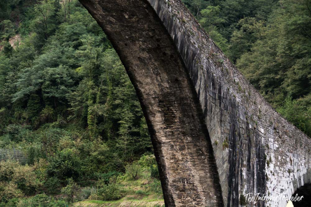 Close-up of the ancient stone arch of the Ponte della Maddalena in Borgo a Mozzano, Tuscany