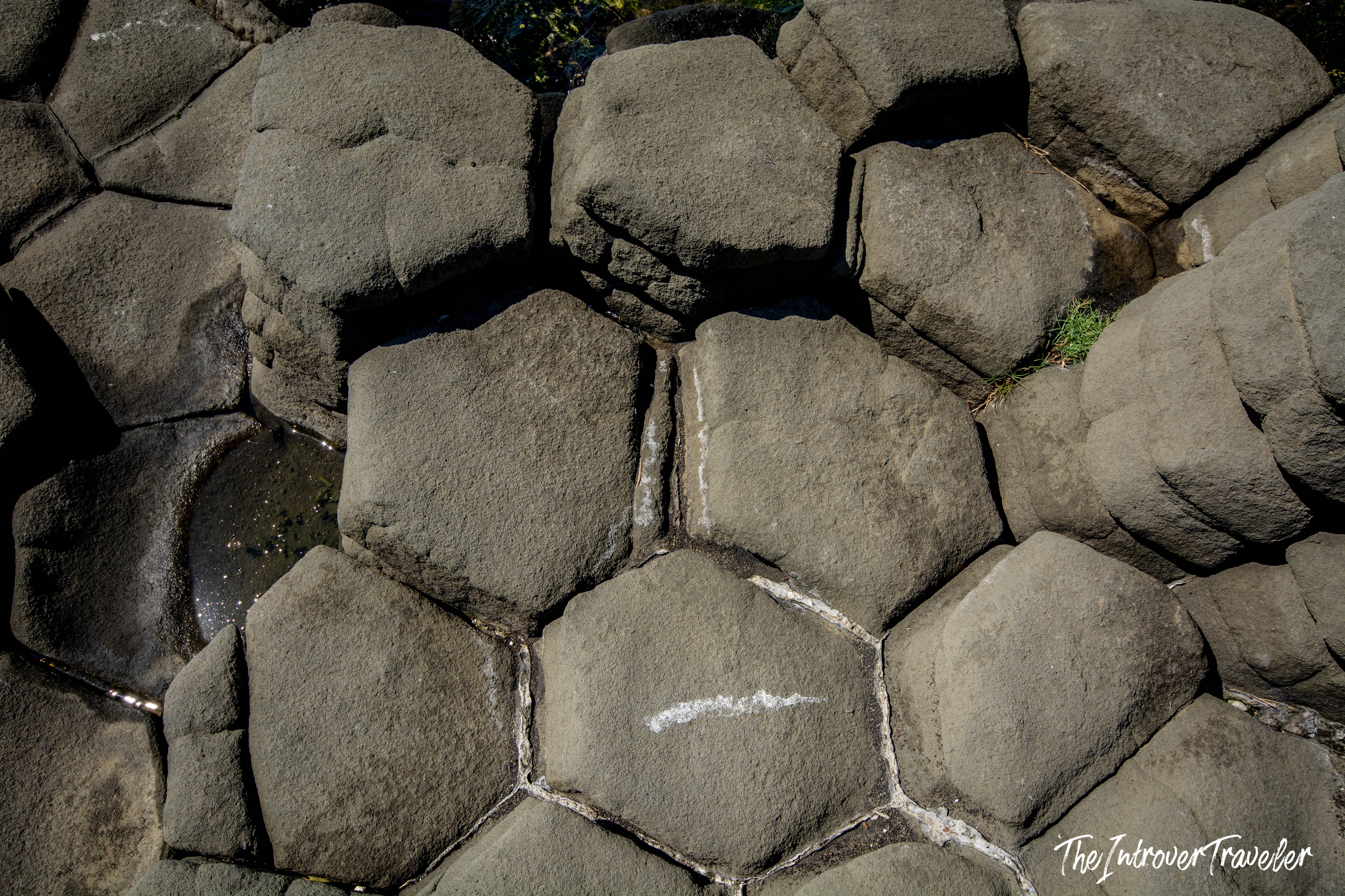 Close-up of hexagonal basalt columns at Aci Trezza, Sicily, formed by ancient Mount Etna lava flows