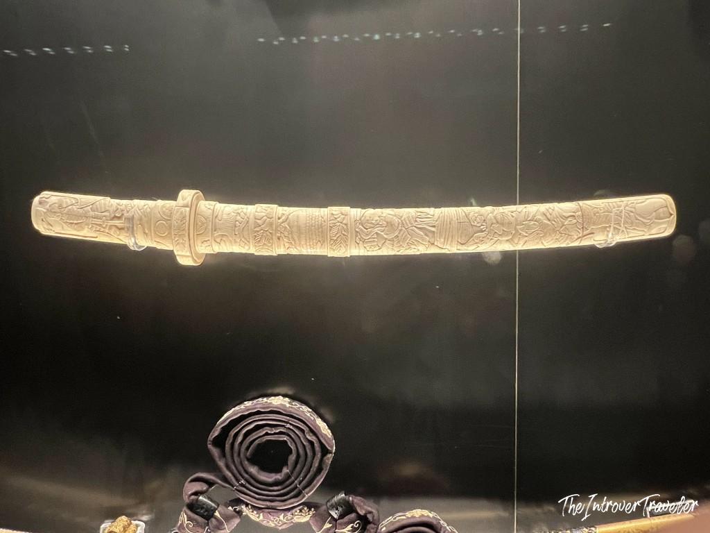 Intricately carved ivory sword on display in a glass case at Topkapi Palace, Istanbul
