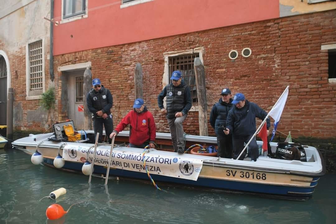 Gondolieri Sommozzatori Volontari di Venezia crew on their dive rescue boat in a Venice canal