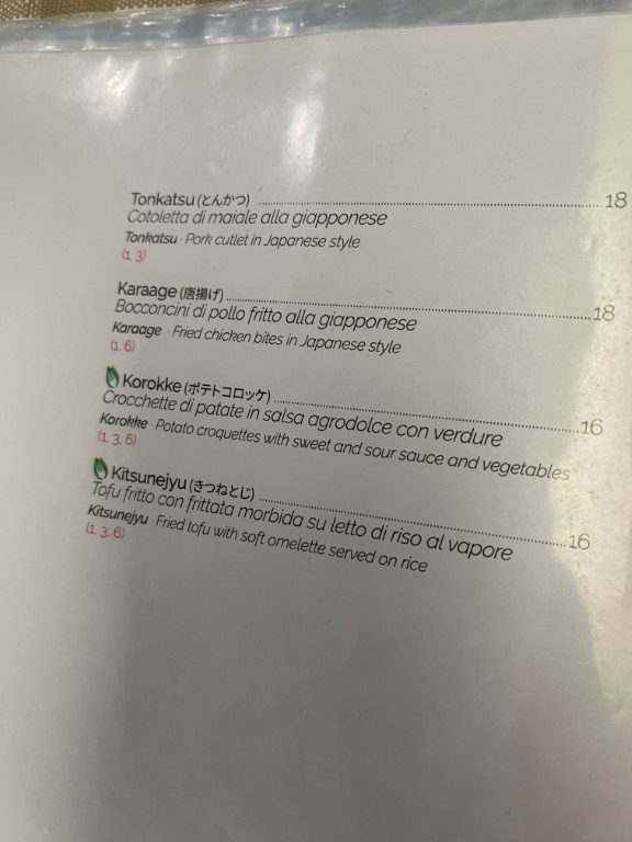 Japanese restaurant menu at Yuzuya Bologna featuring tonkatsu, karaage, korokke, and kitsunejyu dishes