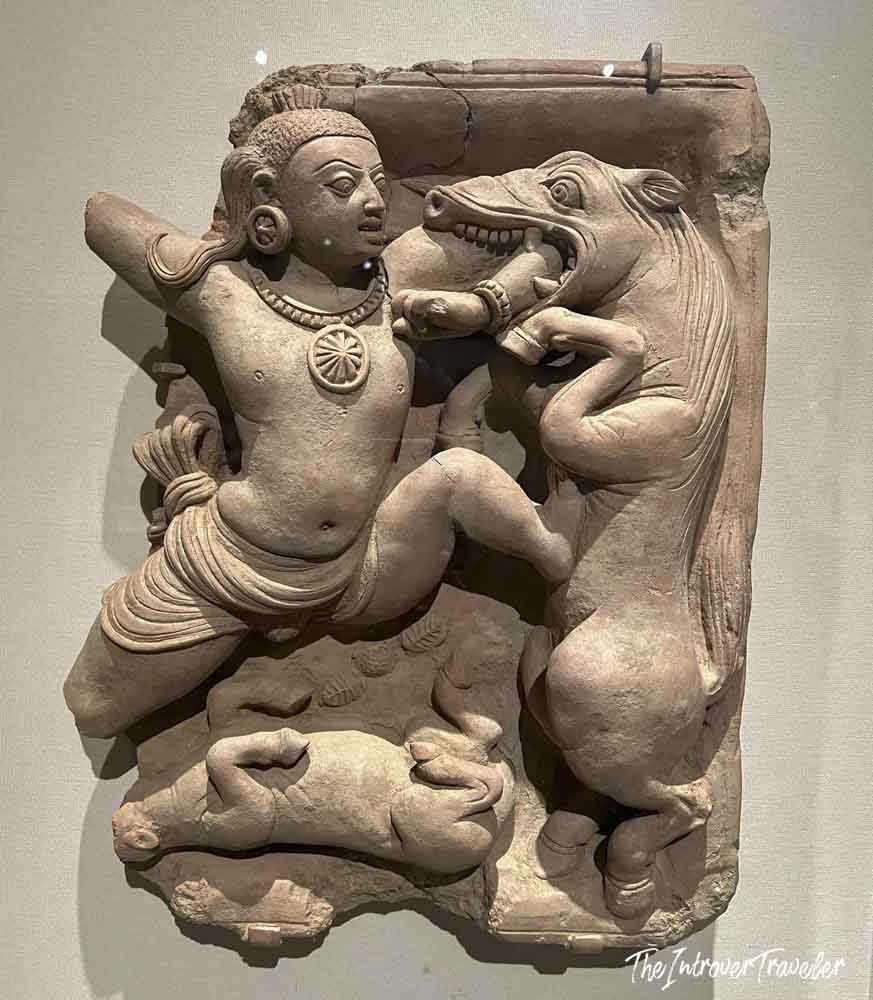 Ancient Indian terracotta relief panel at the Met, depicting a figure wrestling a horse-like creature