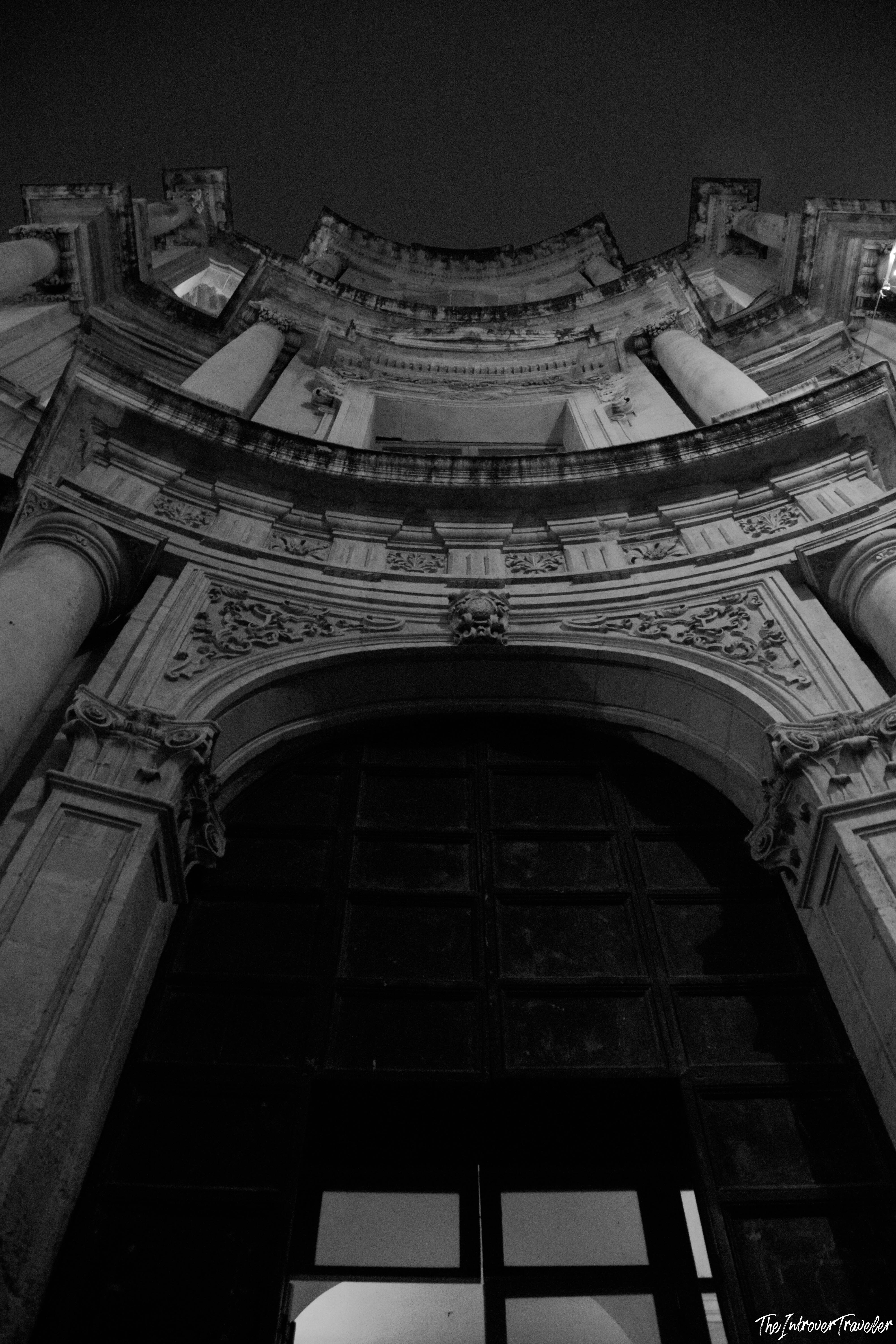 Upward night view of an ornate Baroque church facade in Val di Noto, Sicily