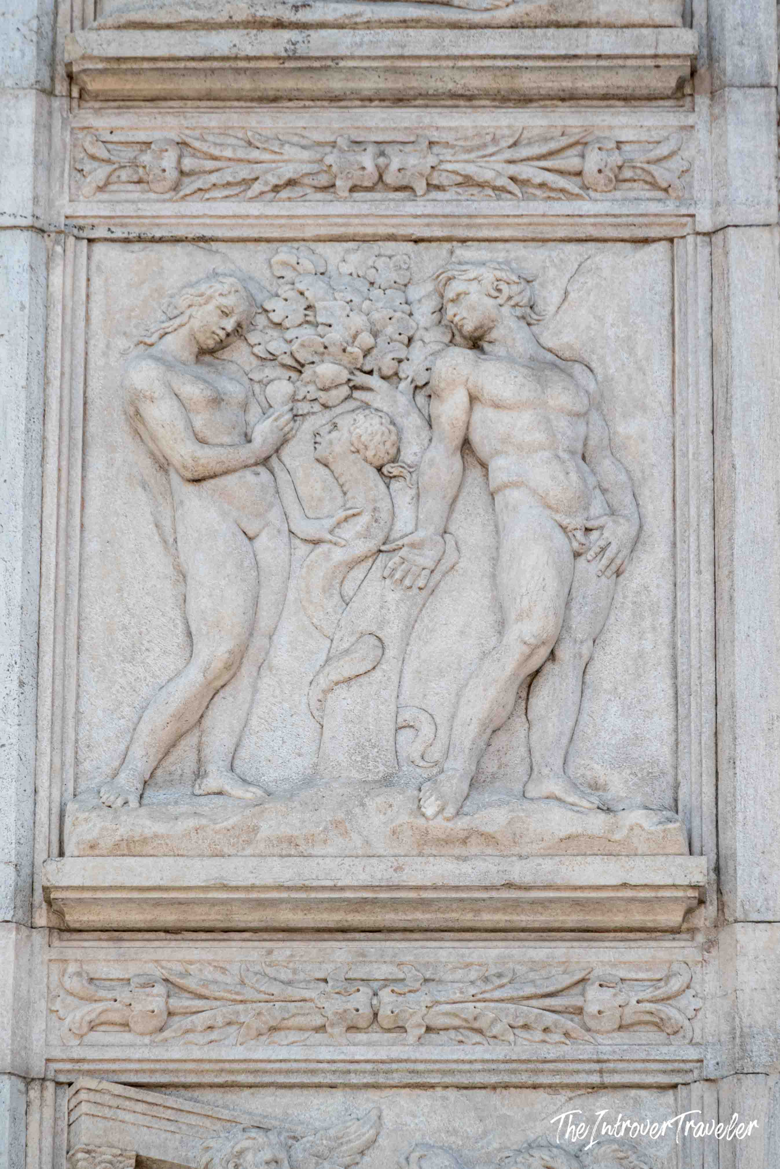 Marble relief of Adam, Eve, and the serpent at the Tree of Knowledge, echoing Sistine Chapel themes